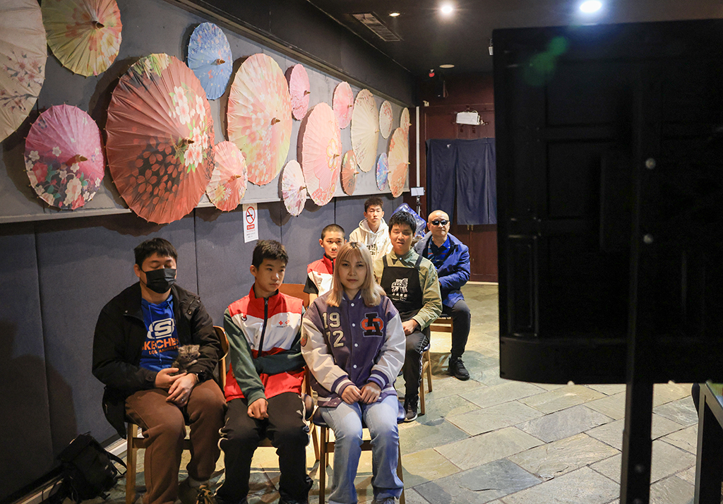 10月26日,在木马童话黑暗餐厅,视力障碍人士和志愿者一起观看无障碍电影。