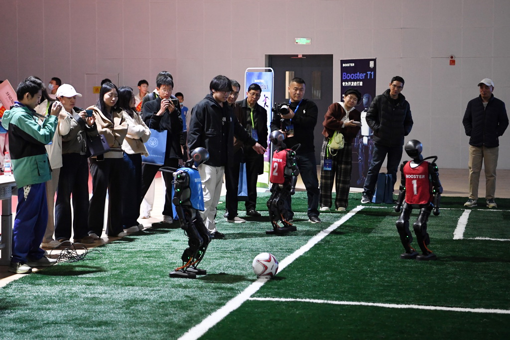 11月15日，人們在人形機器人演示現場觀看一場機器人3對3足球賽。