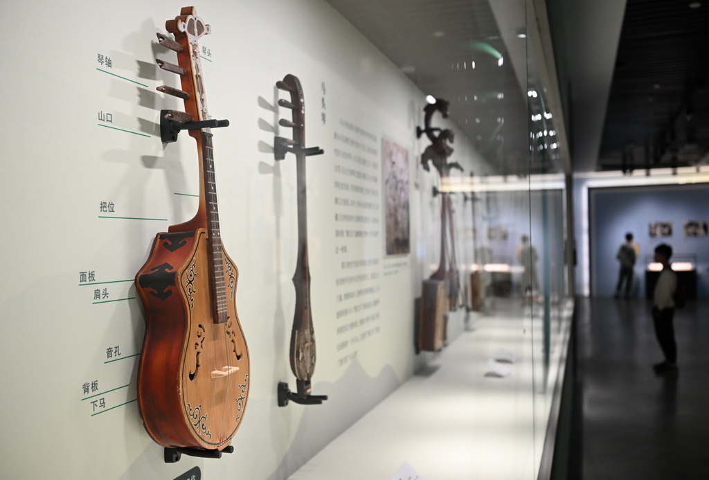 11月29日，参观者观看现场展出的乐器火不思。