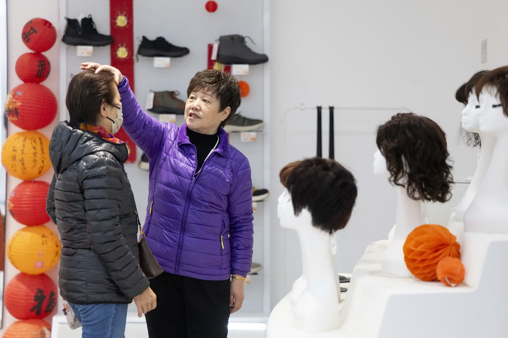 1月15日,上海銀發商店的工作人員為顧客推薦假發。