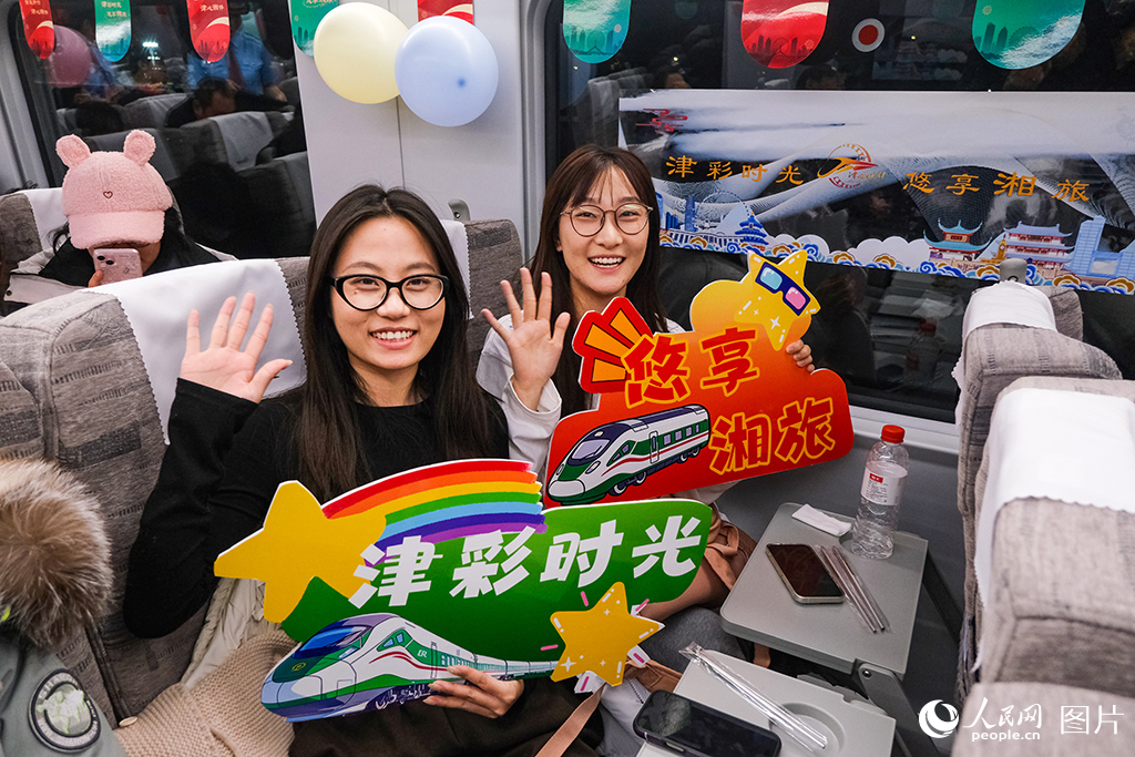 1月19日，列車首發活動中乘車旅客進行互動。楊寶森攝