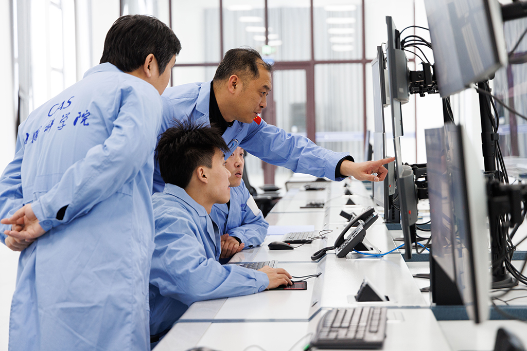 1月24日,施勝浦(左三)、高景飛(左一)、李強(左四)、田冬(左二)在漠河站機房監測衛星數據接收系統運行情況。