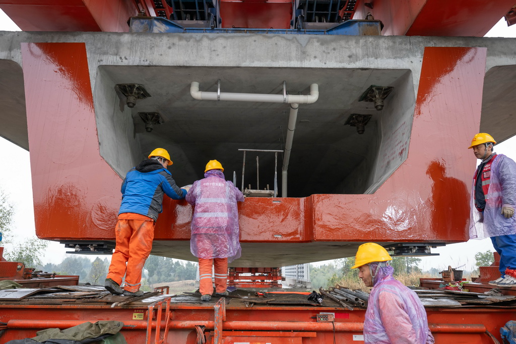 2月9日，工人們在箱梁架設現場作業。
