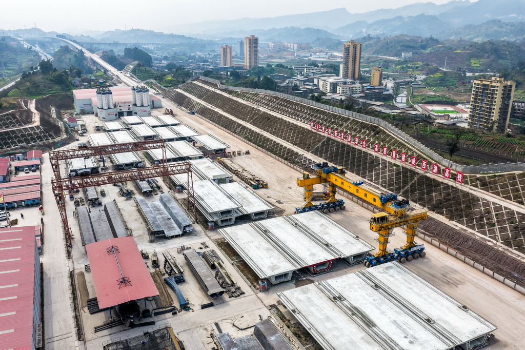 2月26日，在西渝高铁合川东制梁场，大型机械在进行提梁、运梁作业（无人机照片）。