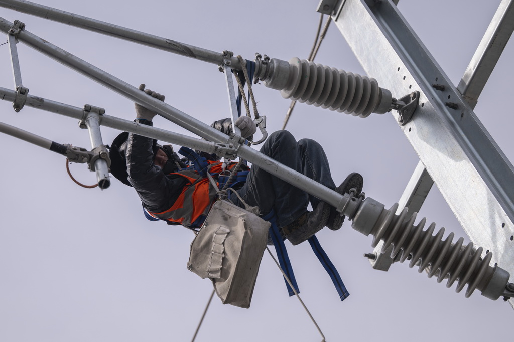 3月13日，工人在哈伊高铁绥化南站施工现场进行接触网作业。