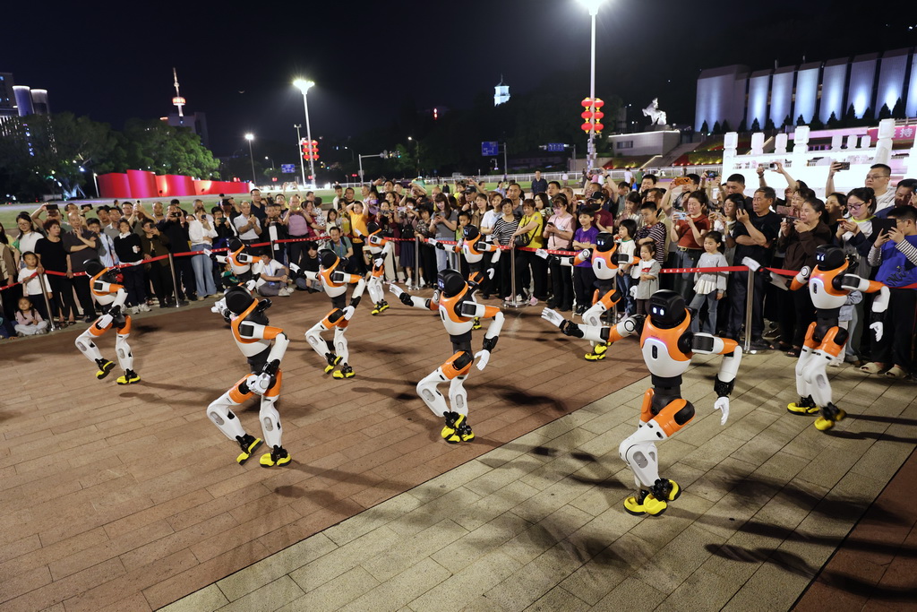 4月19日，在福州五一广场，市民观看机器人表演。