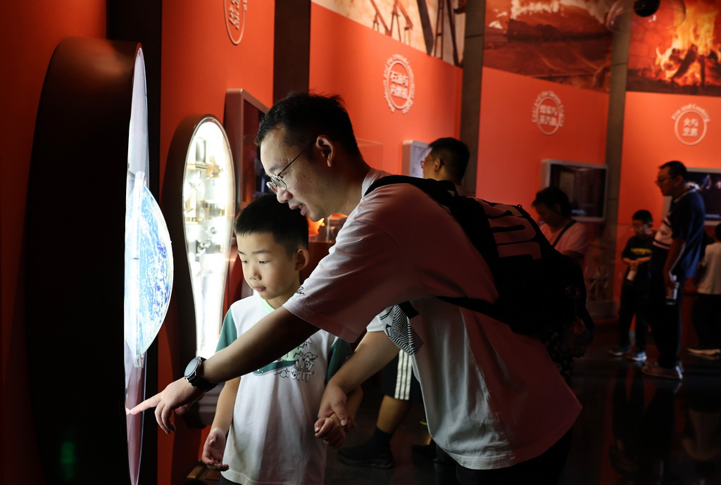 8月18日，参观者在上海科技馆未来能源主题展板前驻足观看。