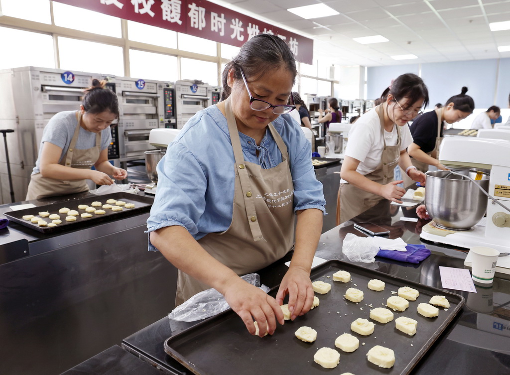 9月7日，在上海市现代食品职业技能培训中心教学点，上海市民日校的学员们在西点烘焙手作课上制作杏仁饼干。