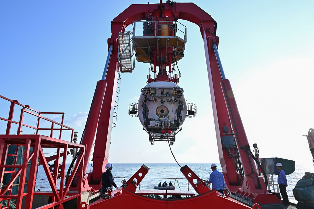 10月10日， “深海一號”船A型架將“蛟龍”號緩緩吊至海面。